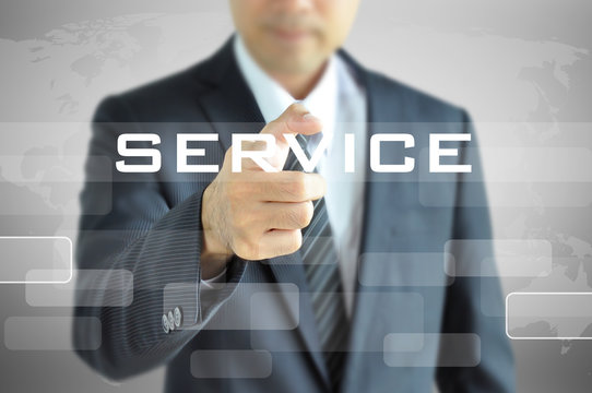Businessman pointing to SERVICE word on virtual screen