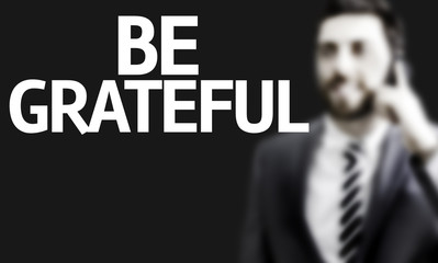 Business man with the text Be Grateful