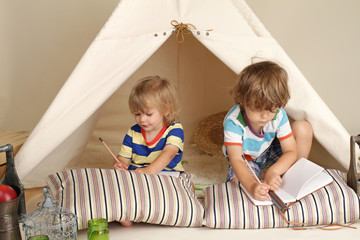 Child playing in teepee tent
