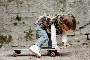 little hipster girl with skateboard portrait