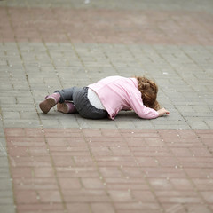 alone crying girl lying on asphalt