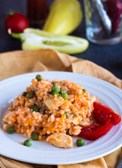 Risotto with chicken, peas and tomatoes, Italian cuisine