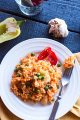 risotto with chicken and vegetables on a plate with fork