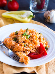 risotto with chicken and vegetables on a plate with fork