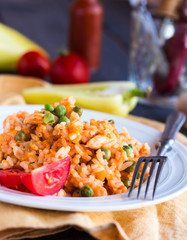 risotto with chicken and vegetables on a plate with fork