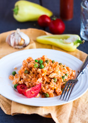 risotto with chicken and vegetables on a plate with fork