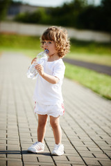 little girl drinking clean water from bottle