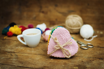 Cup of coffee, heart shaped crochet coasters and yarns