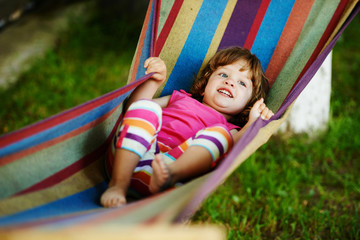 Fototapeta na wymiar cute girl resting lying on hammock