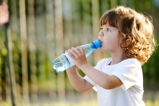 little girl drinking clean water from bottle