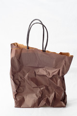 One brown crumpled shopping paper bag
