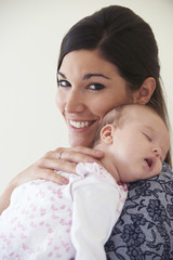 Mother Cuddling Sleeping Baby Daughter