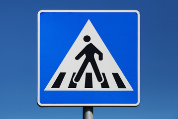 Pedestrian crossing. Road sign above blue sky background