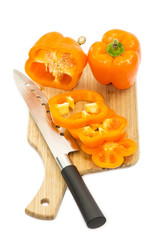 pepper on a cutting board and knife