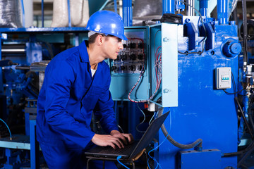 young electrician analyzing data on his laptop