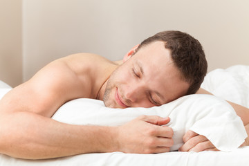 Fototapeta na wymiar Portrait of pleased sleeping Young Caucasian man