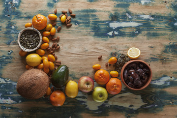 Fresh fruit, nuts and seeds on a rustic table
