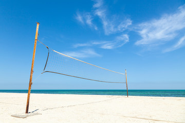Net for beach volleyball on empty sea coast