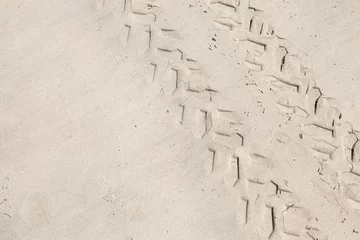 Zelfklevend Fotobehang ATV tracks on the white sand beach. Closeup photo © evannovostro