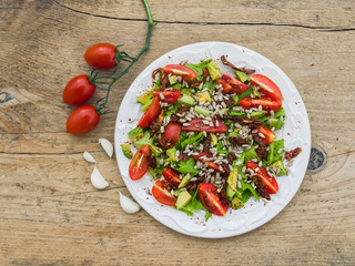Fresh vegetable salad on a wooden board