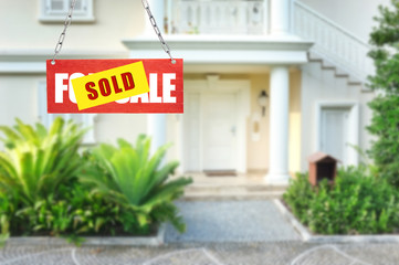 Sold home for sale real estate sign and beautiful new house