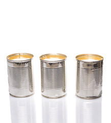 Condensed milk in tin can over white background 