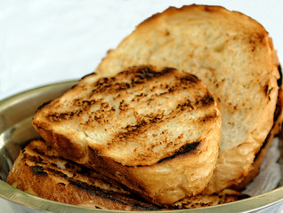 Fresh toasted sliced white bread in metal bowl