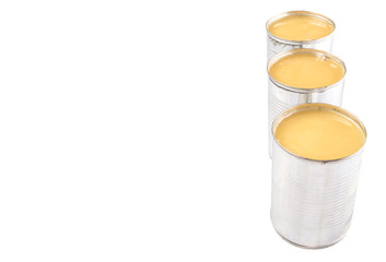 Condensed milk in tin can over white background 