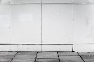 Urban background interior with white metal wall and concrete pav