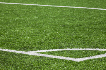 Obraz premium Football playing field background with green grass and white cor