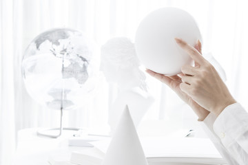 Hand holding a sphere