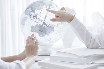Woman pointing at globe