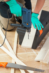 Drilling a hole in the wooden plank