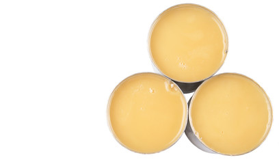 Condensed milk in tin can over white background 