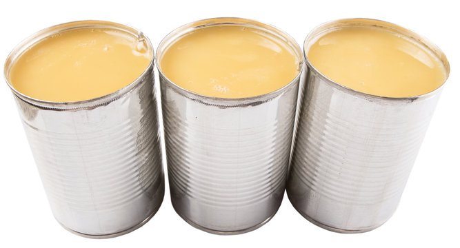 Condensed Milk In Tin Can Over White Background 