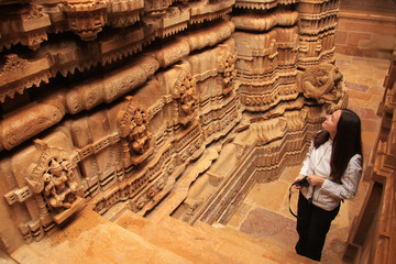 Young woman admiring interior of Jain temple, Jaisalmer, Rajasth