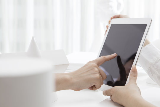 Hand of a woman touching the tablet