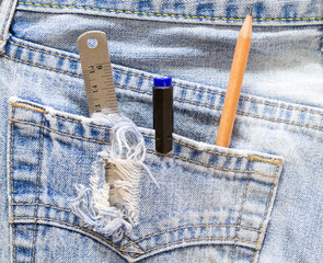 Ruler, pen and pencil in the blue jeans back pocket.