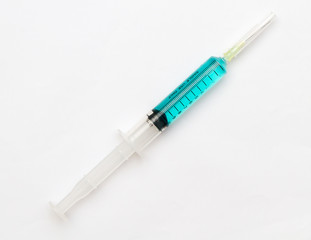 Blue vaccine in syringes with cover pin.