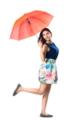 Young asian woman holding a umbrella in the wind