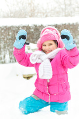 Little child playing in snow