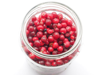 cranberries in a pot on a white background