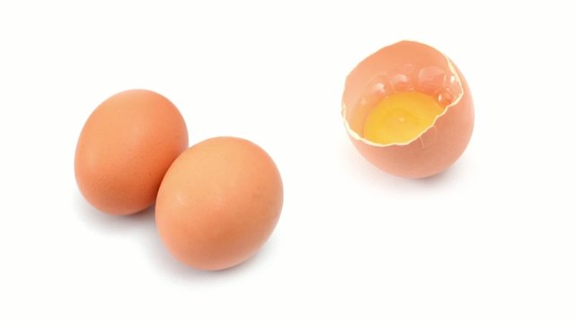 raw eggs rotating on white background