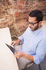 Businessman using digital tablet at desk