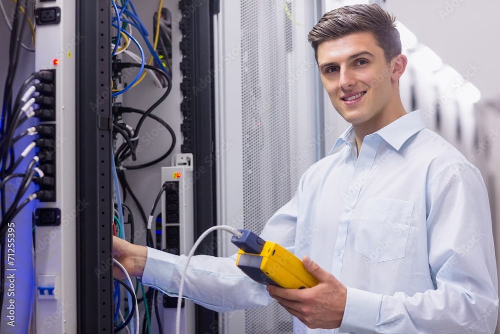 Aufkleber Technician smiling at camera while fixing server