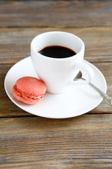 white coffee cup and pink macaroon