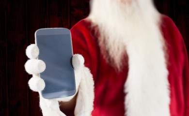 Obraz na płótnie Canvas Composite image of santa claus showing smartphone