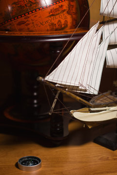 model sailing ship and old globe