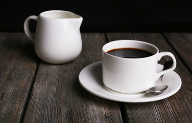 Cup of coffee and cream in milk jug