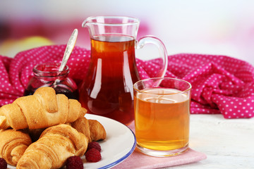 Breakfast with apple juice, jam and fresh croissants